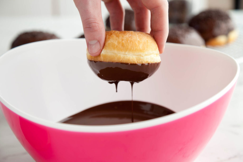Dipping donuts in chocolate