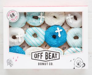 Offbeat Donuts Communion box with blue and white donuts featuring cross decorations and icing details